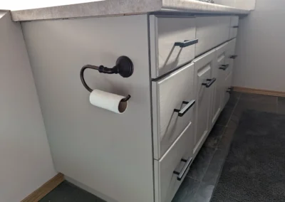 a bathroom with cabinets that were finished and painted by FHG Contracting