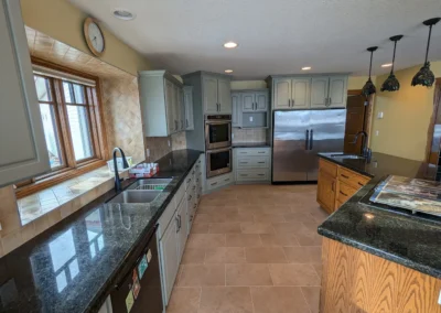 Kitchen cabinets that were refinished and painted in an Alberta kitchen by FHG Contracting