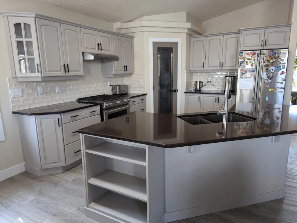 a kitchen that had its counters and cabinets painted gray by fhg contracting in beaumont alberta canada