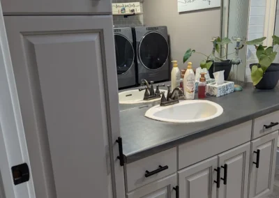 a bathroom with cabinets that were finished and painted by FHG Contracting