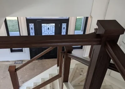 Staircase in Canada with wood refinished and stained by FHG Contracting