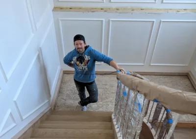 Staircase in the process of having its wood refinished and stained by FHG Contracting