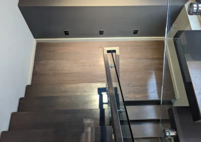 Staircase in Canada with wood refinished and stained by FHG Contracting