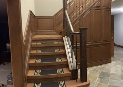 Staircase in Canada with wood refinished and stained by FHG Contracting