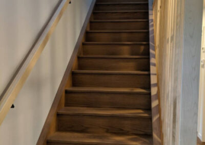 Staircase in Canada with wood refinished. stained and lacquered by FHG Contracting