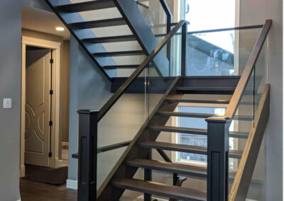 Staircase in Canada with wood refinished and stained by FHG Contracting